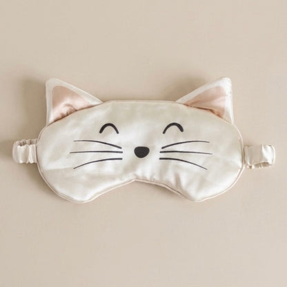 Cat-shaped sleep mask on a beige background